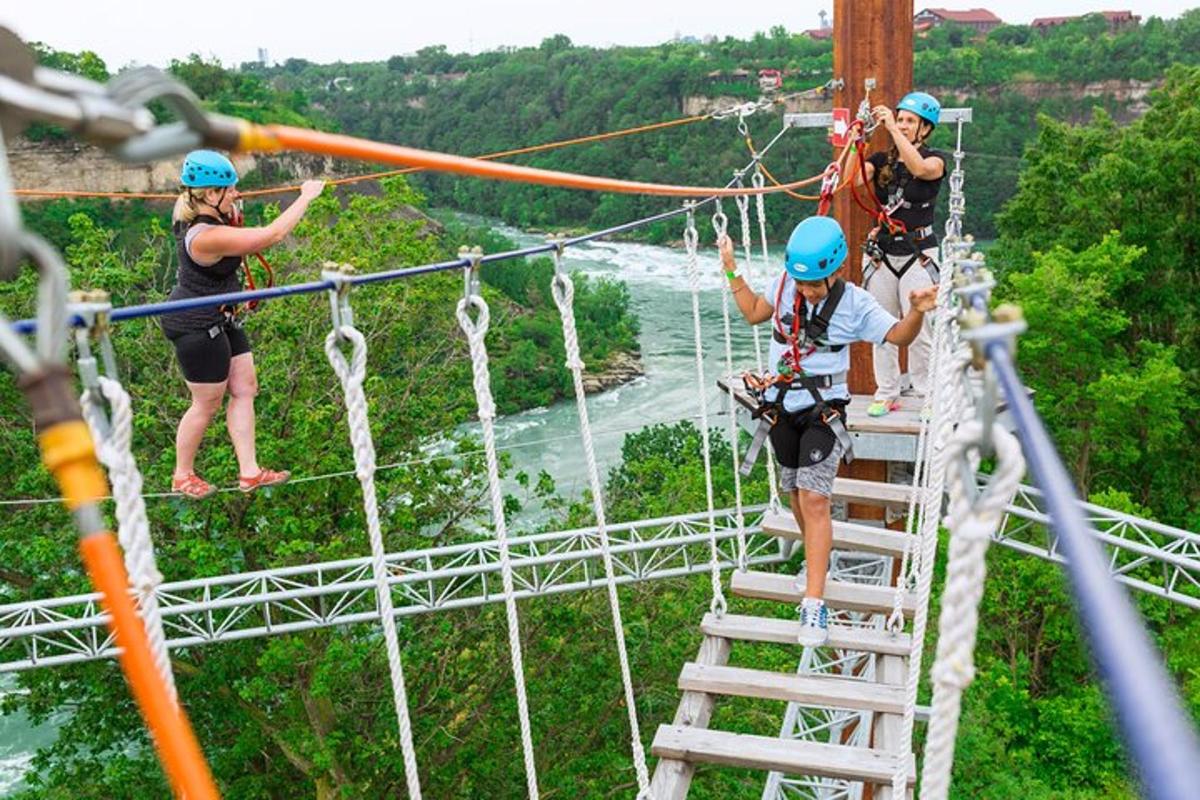 a group of people on a zip line over a river