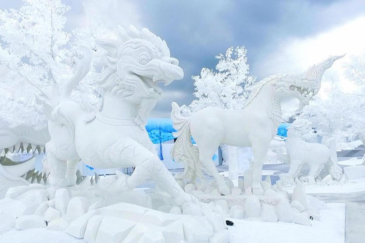 a white statue of horses in the snow