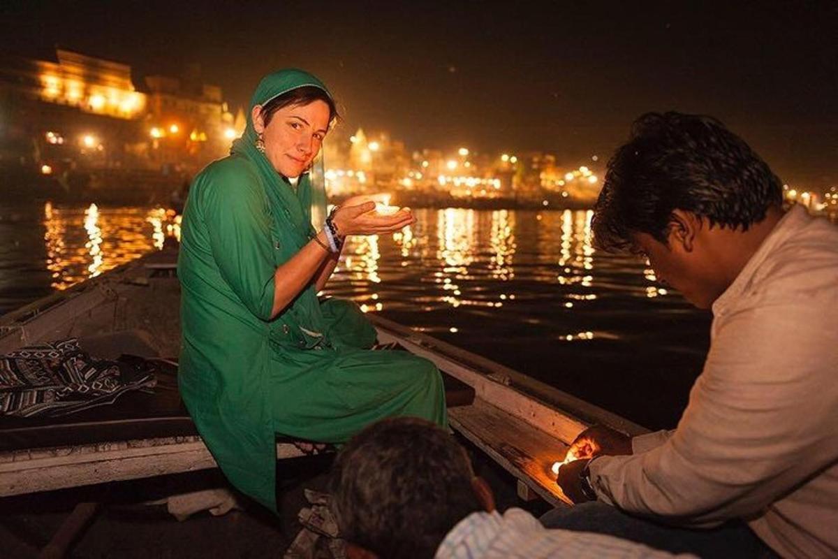 a woman in a green dress sitting on a boat