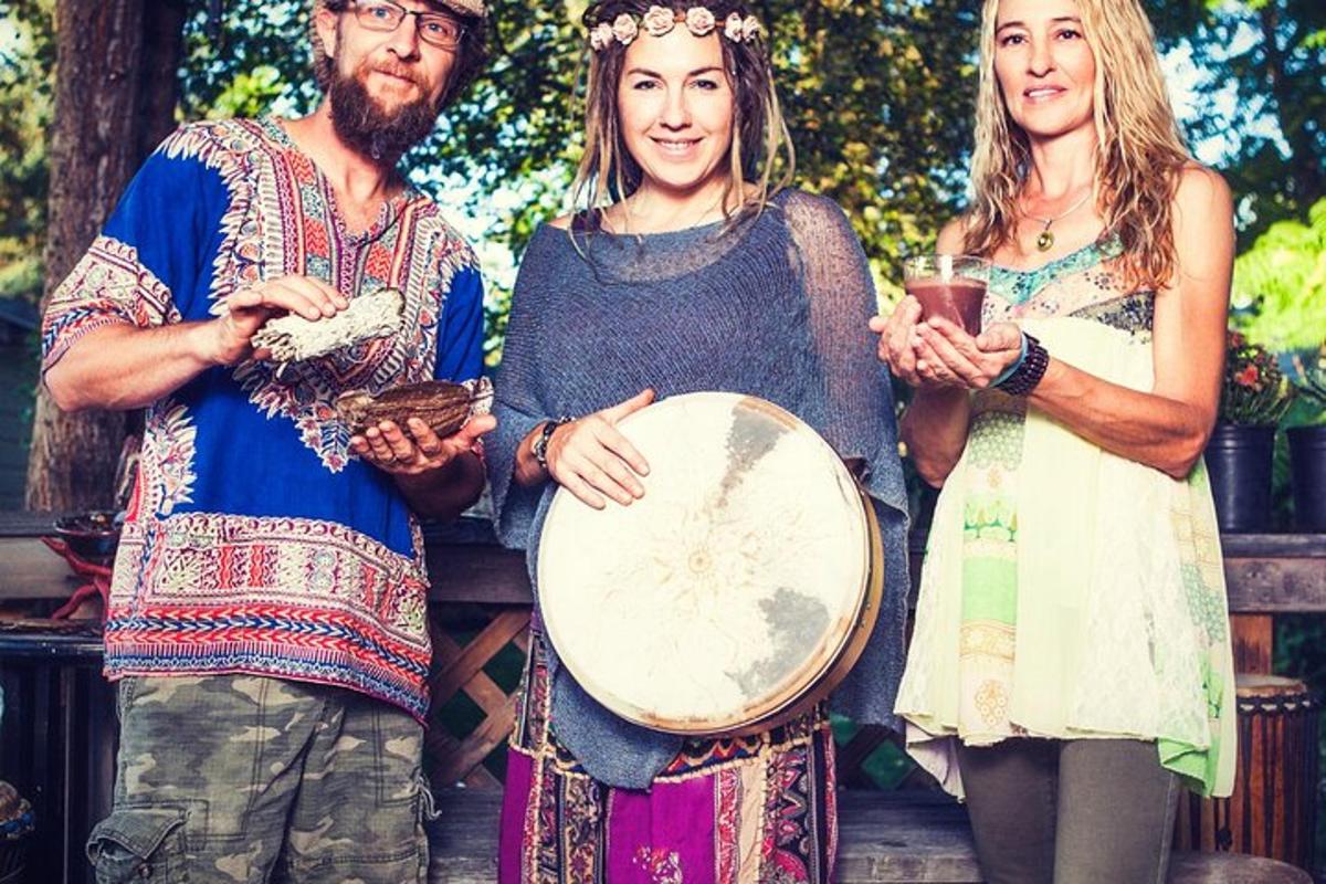 a group of three people standing next to a drum