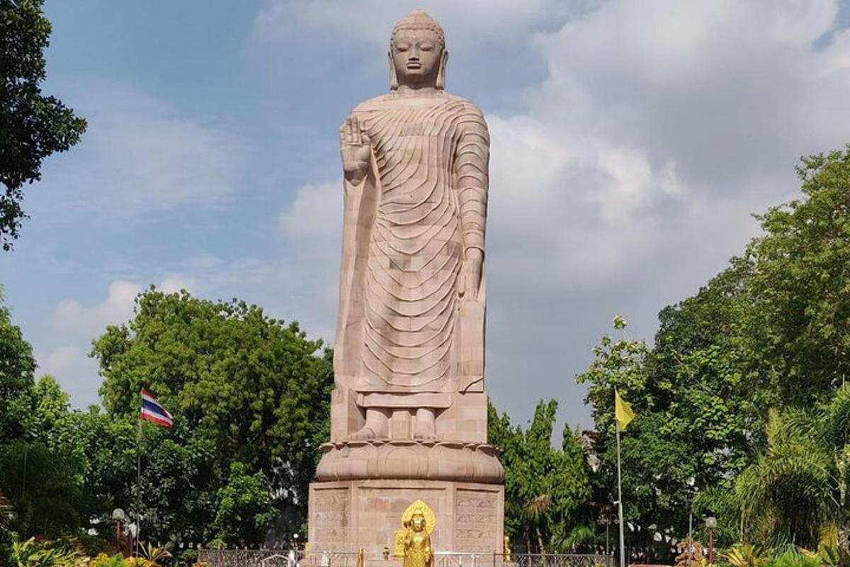 a statue of a woman standing in a park