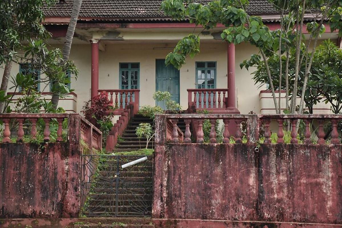 a house with a rusted fence in front of it