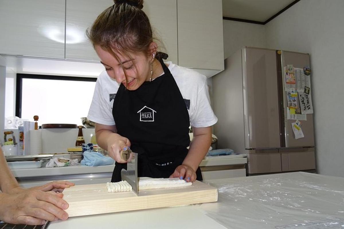 a woman in a kitchen preparing food on a cutting board