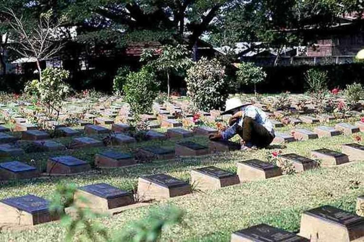 a person sitting in front of a cemetery