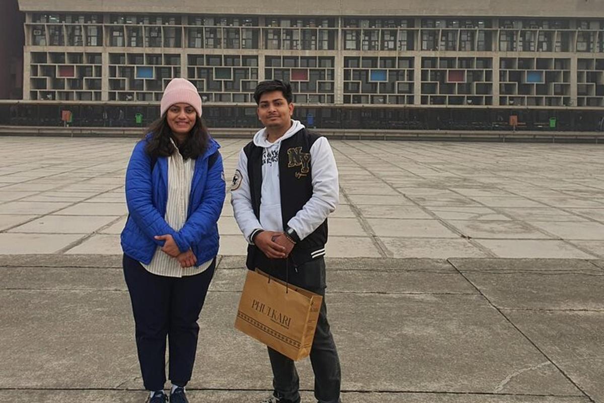 a man and a woman standing in front of a building