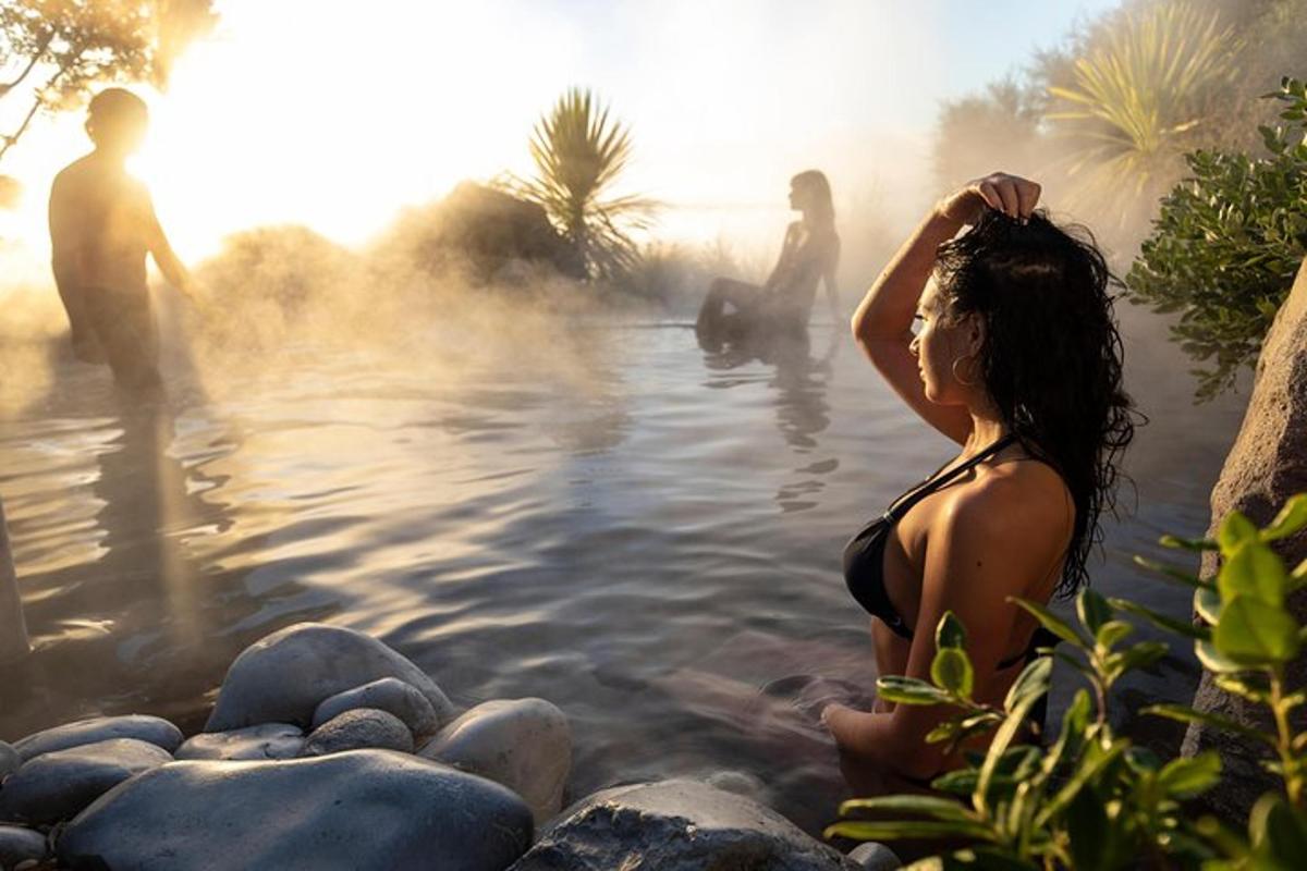 a woman sitting in the water in a hot tub