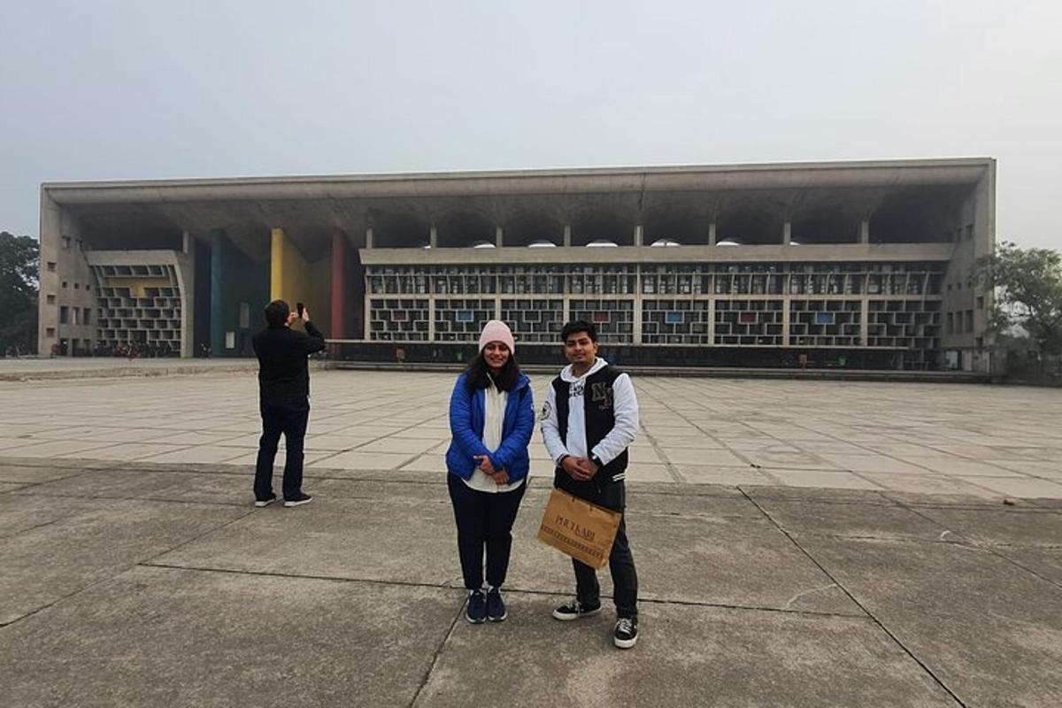 a man and a woman standing in front of a building
