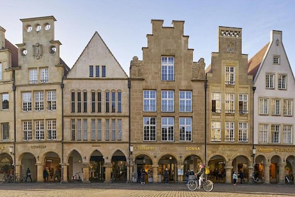 a large building with a person riding a bike in front