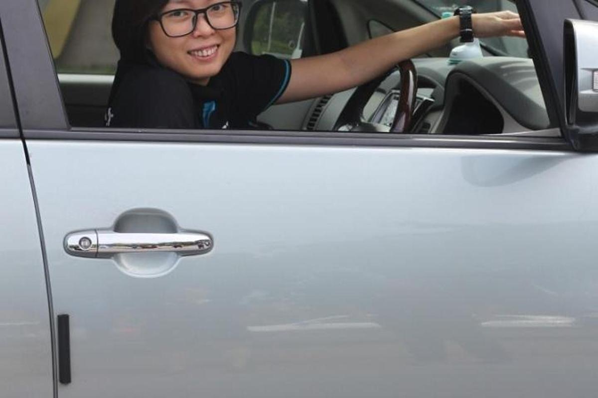 a woman sitting in the drivers seat of a car