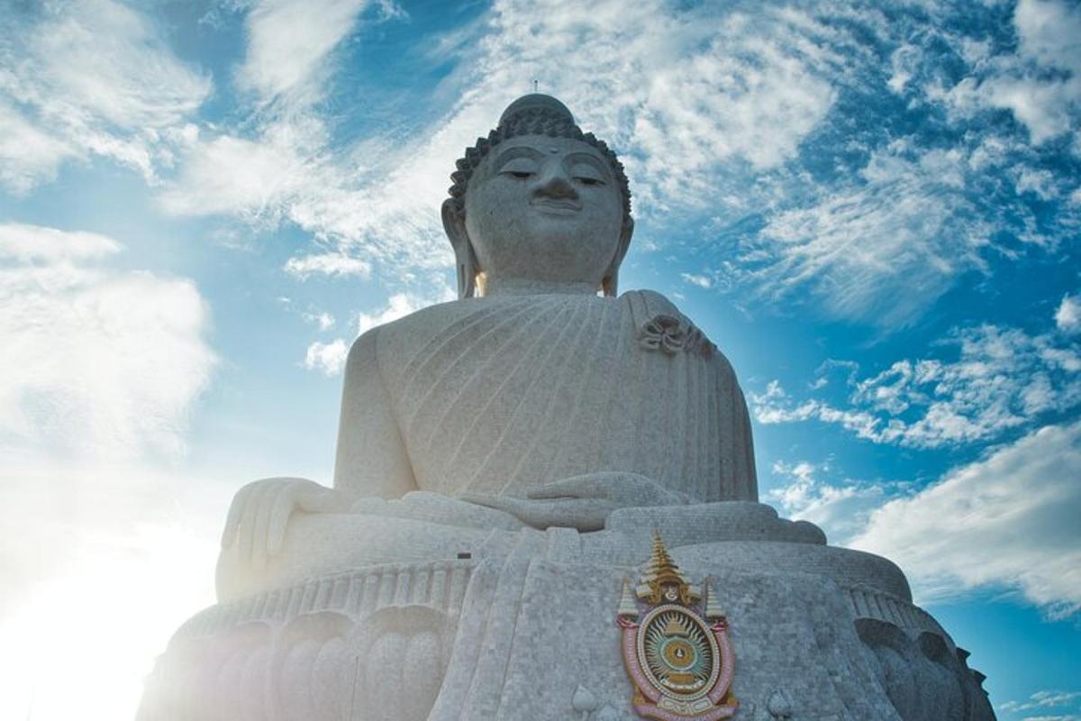 a large white statue on a cloudy sky