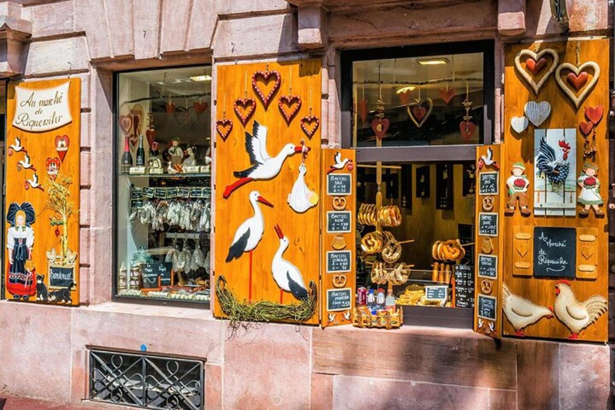 a store front with birds painted on the windows