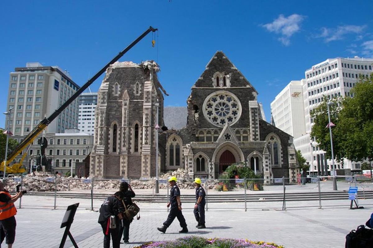 three construction workers walking in front of a church