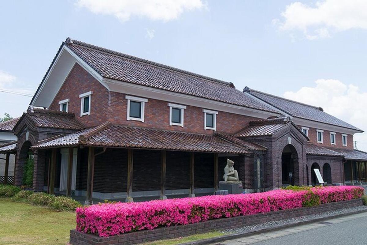 a brick building with pink flowers in front of it