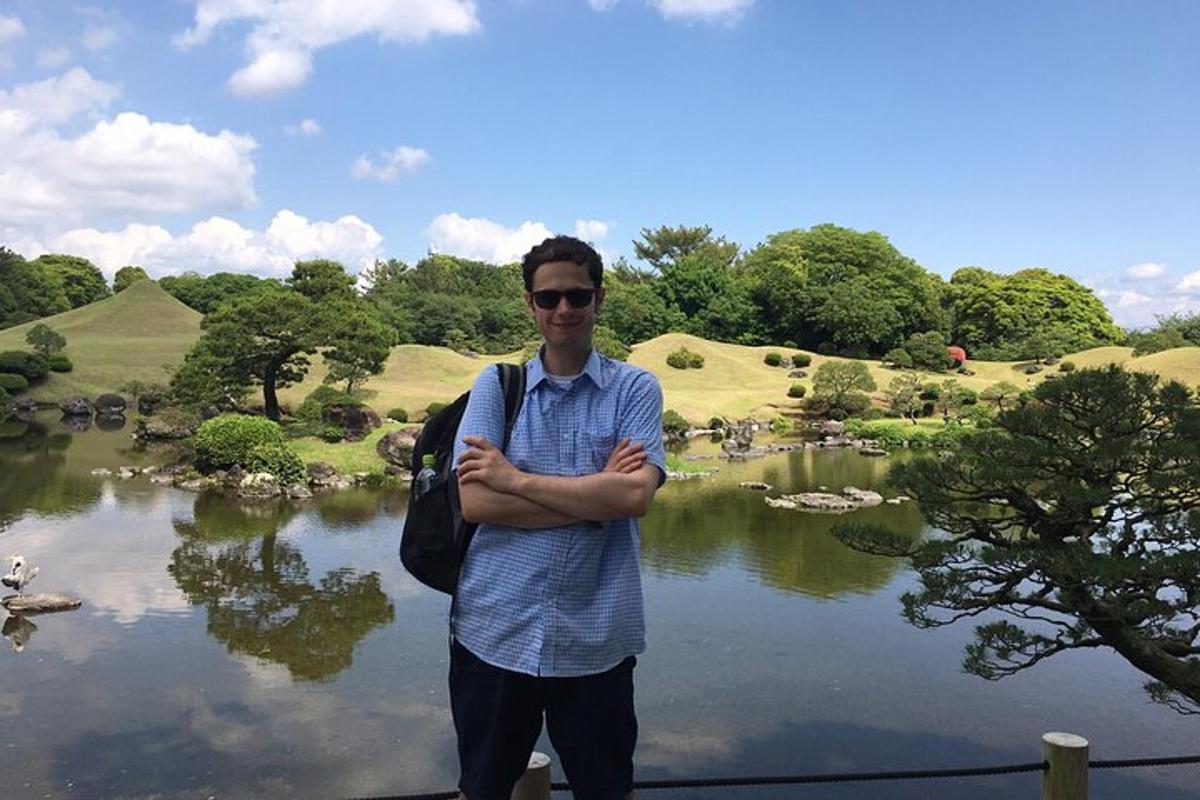 a man is standing in front of a pond