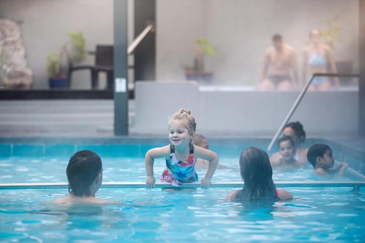 a group of children swimming in a swimming pool