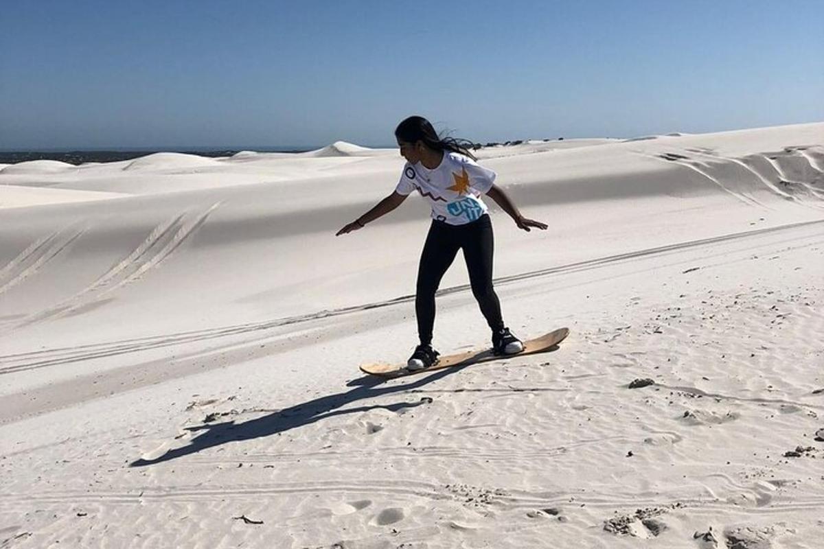 eine Frau steht auf einem Surfbrett in der Wüste