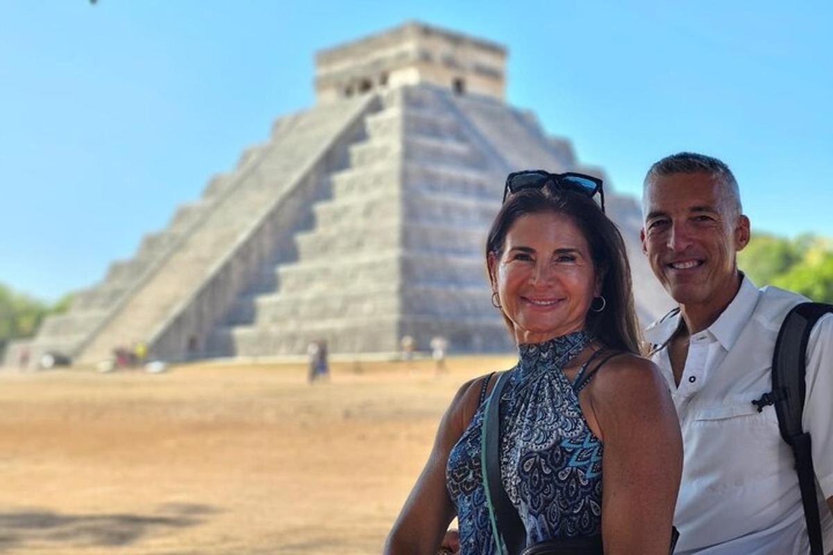 a man and a woman standing in front of a pyramid