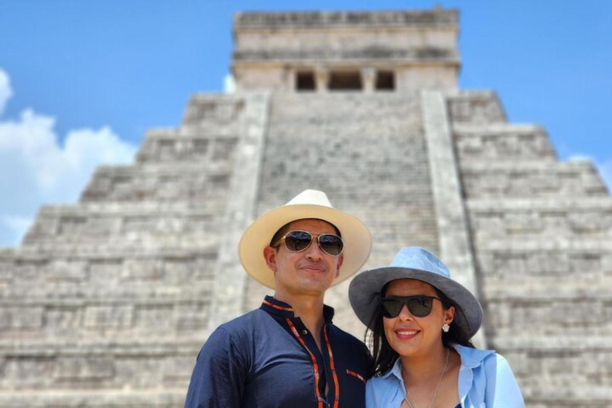 a man and a woman standing in front of a pyramid