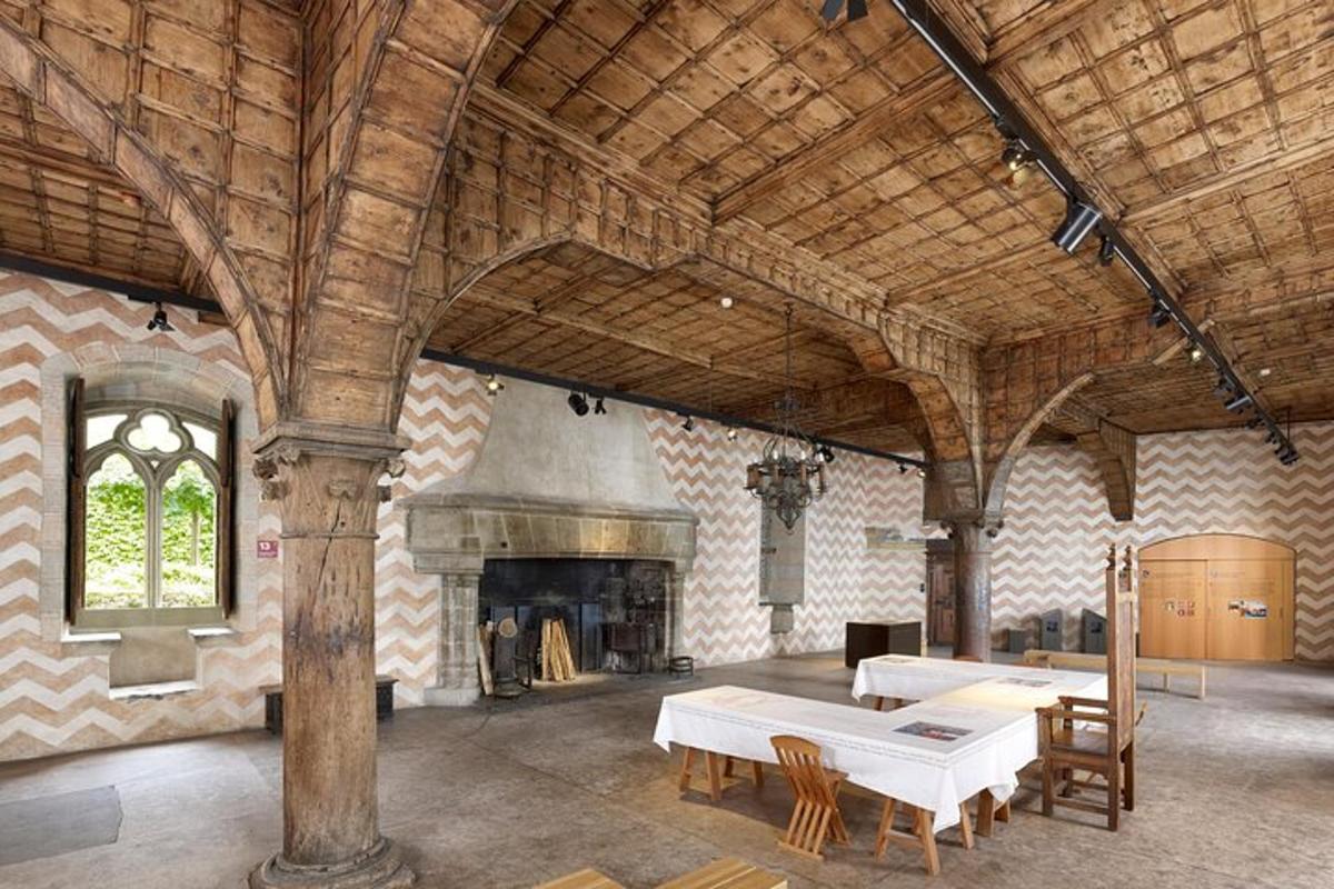 a large room with a table and a fireplace
