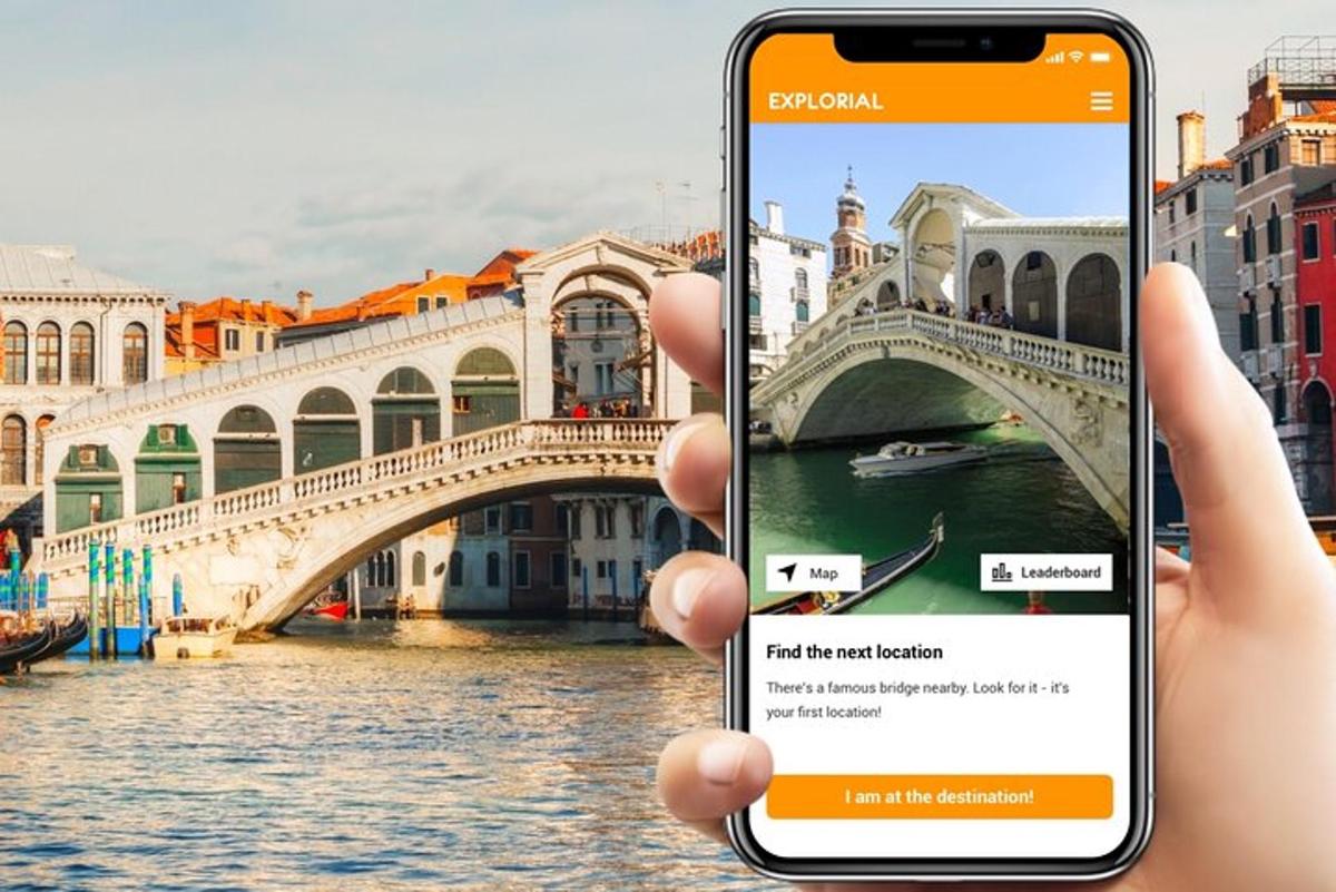 a person holding up a cell phone in front of a bridge