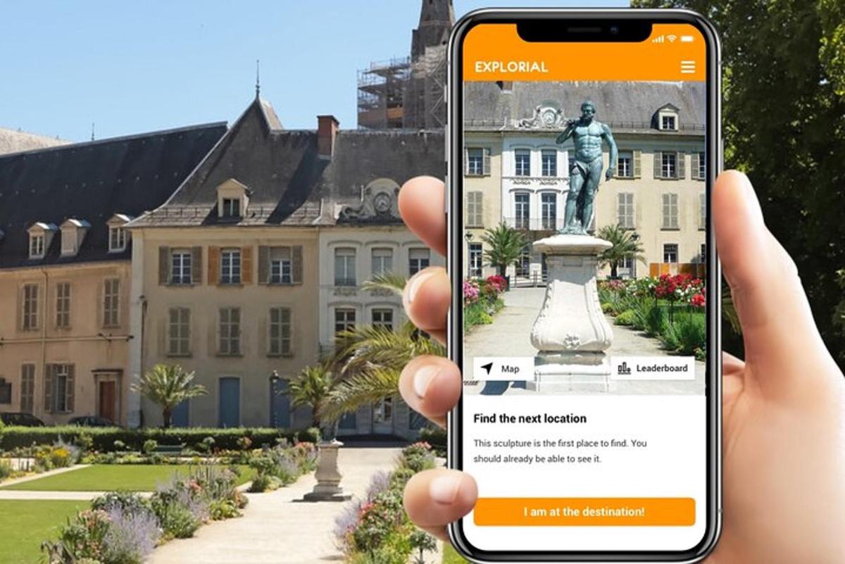 a person taking a picture of a statue in front of a building