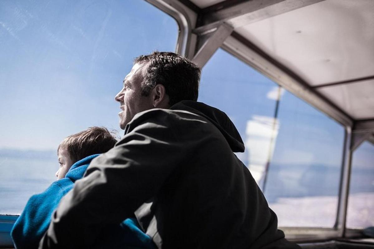 a man and a child looking out the window of a bus