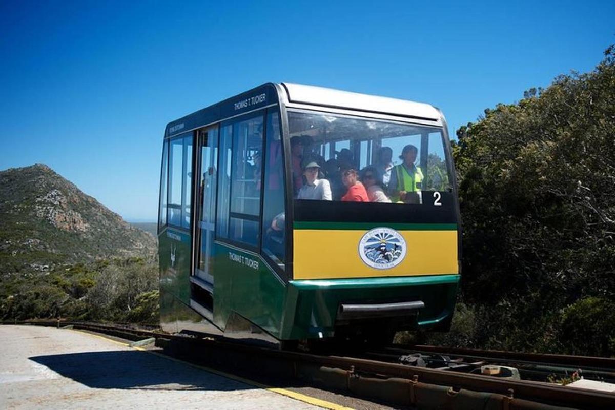 a green and yellow trolley car on the tracks