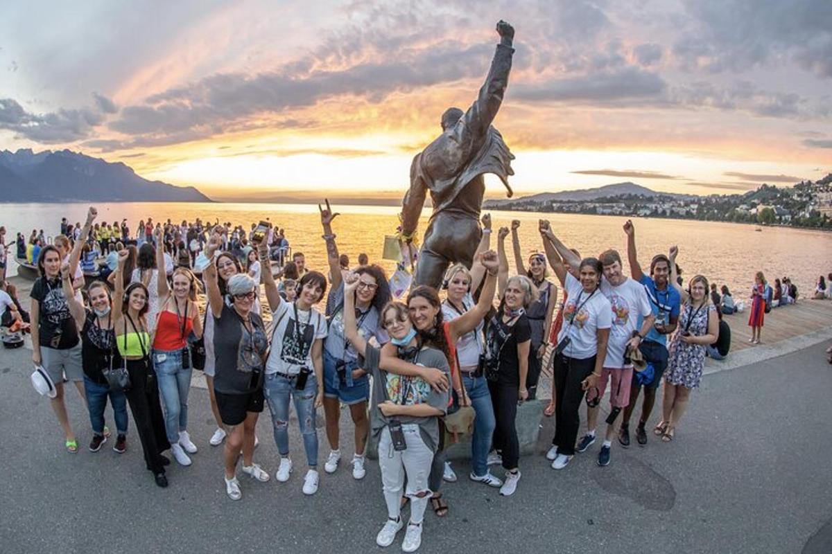 a group of people standing in front of a statue