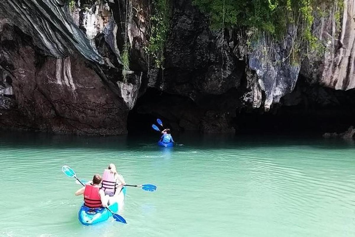 a group of people riding in kayaks in a cave