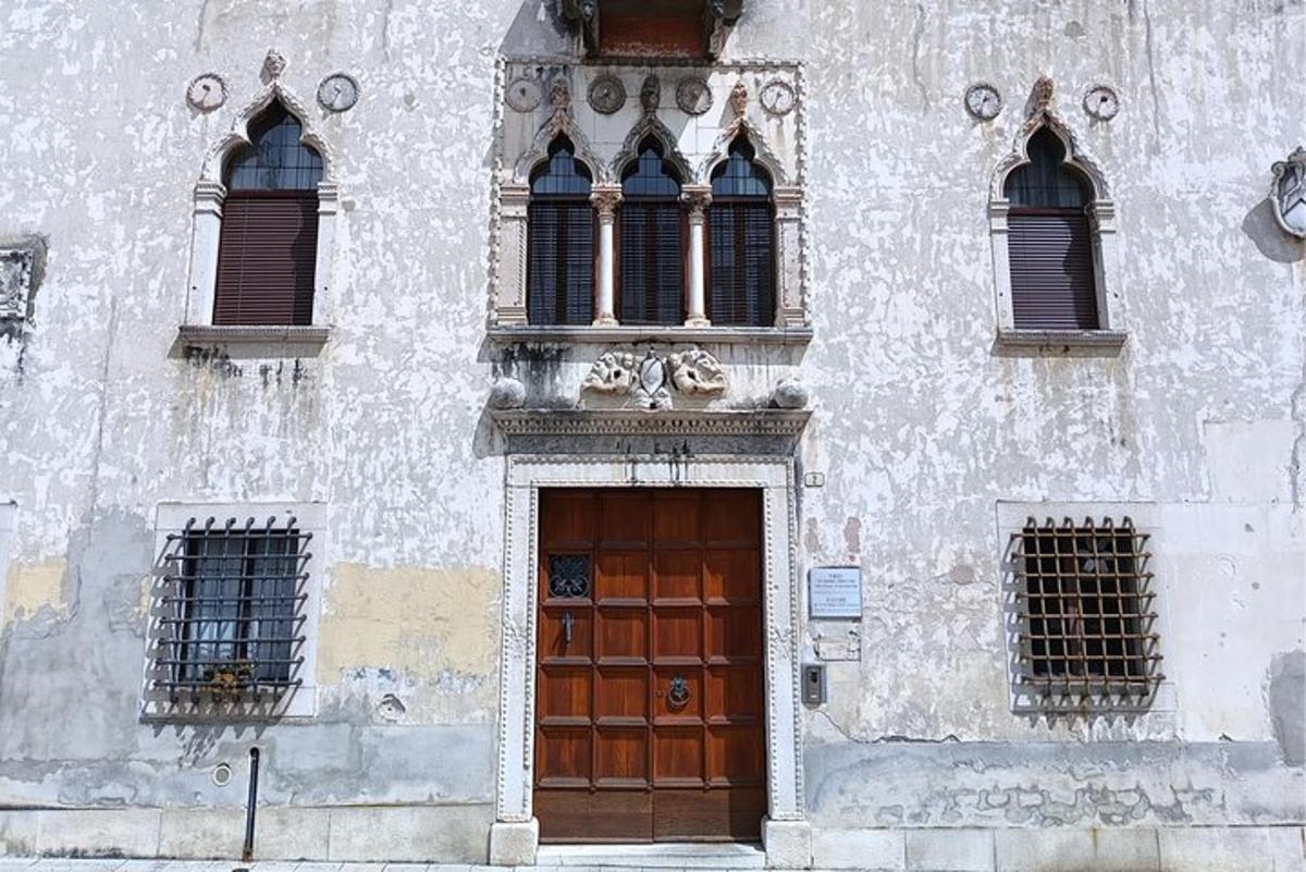 a building with a wooden door and three windows