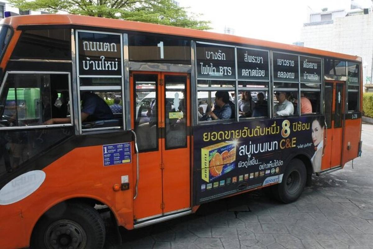 isang orange at itim na bus na puno ng mga tao