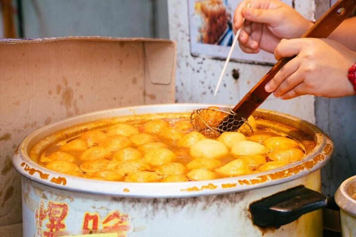 a person is stirring a pot of food with a spoon