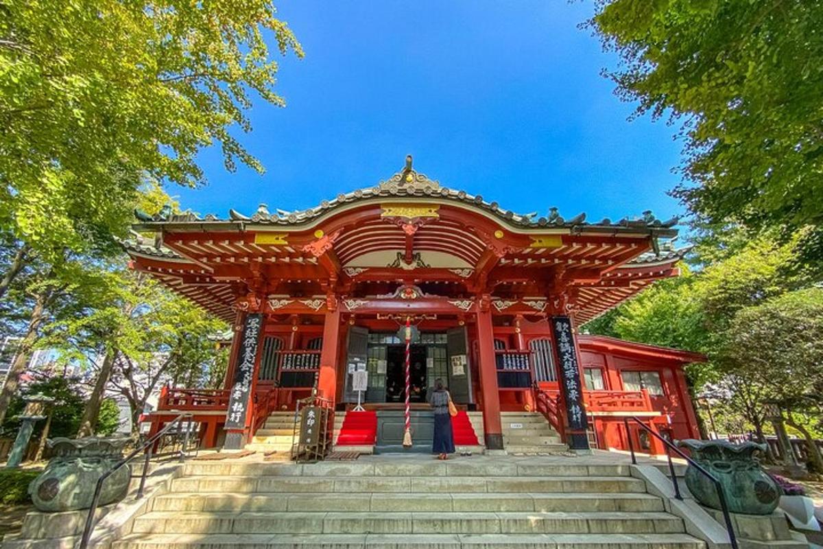 a woman standing in front of a red building
