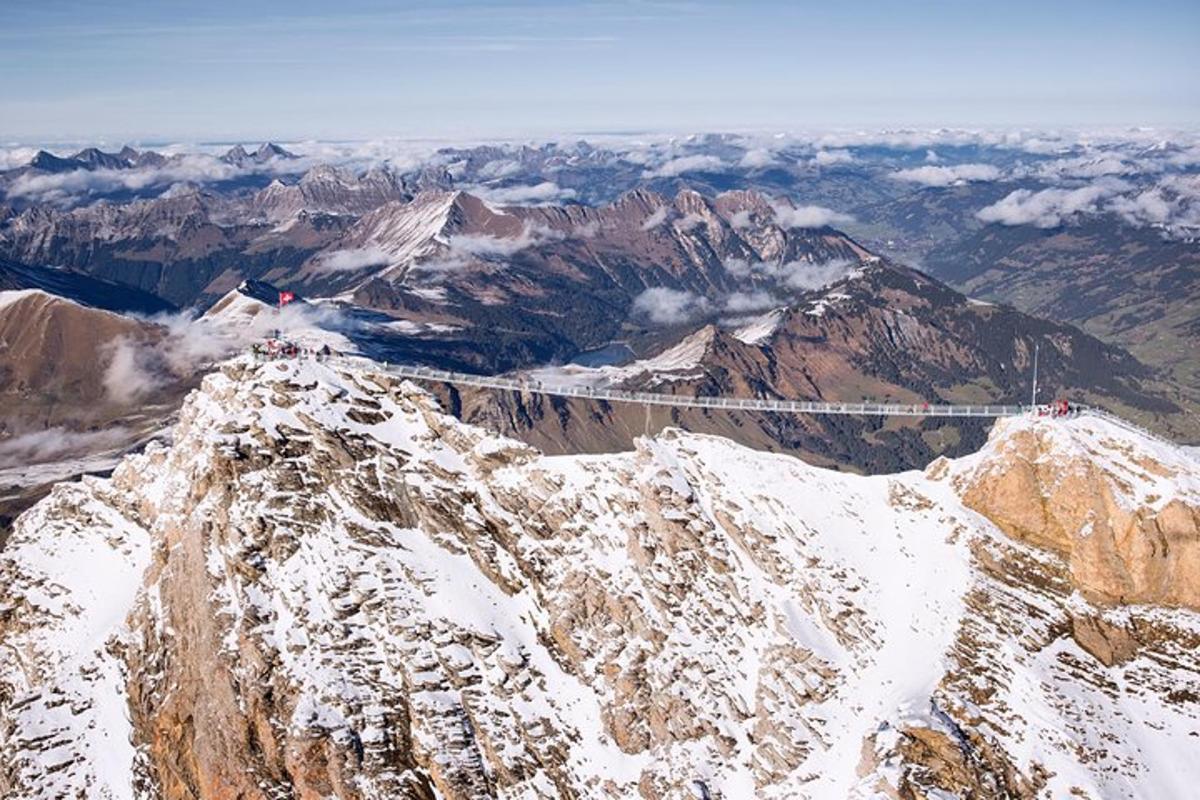 a bridge on top of a mountain with snow