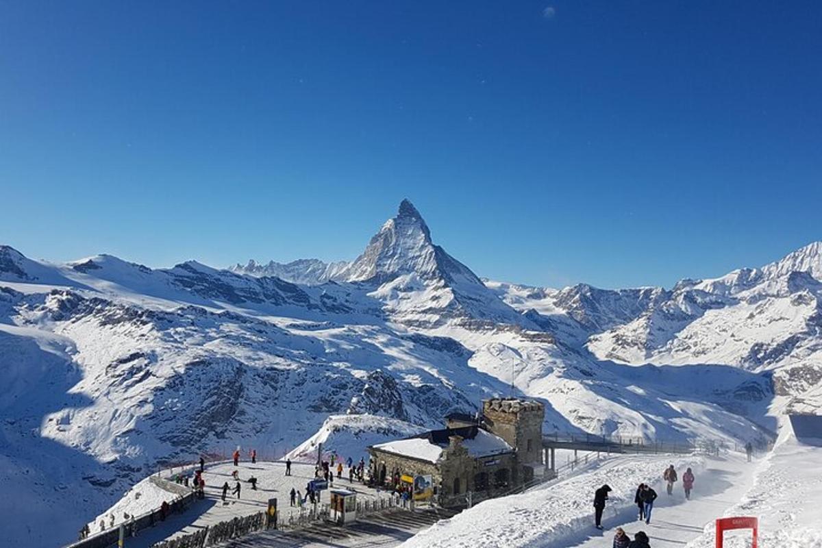 a group of people standing on a snow covered mountain