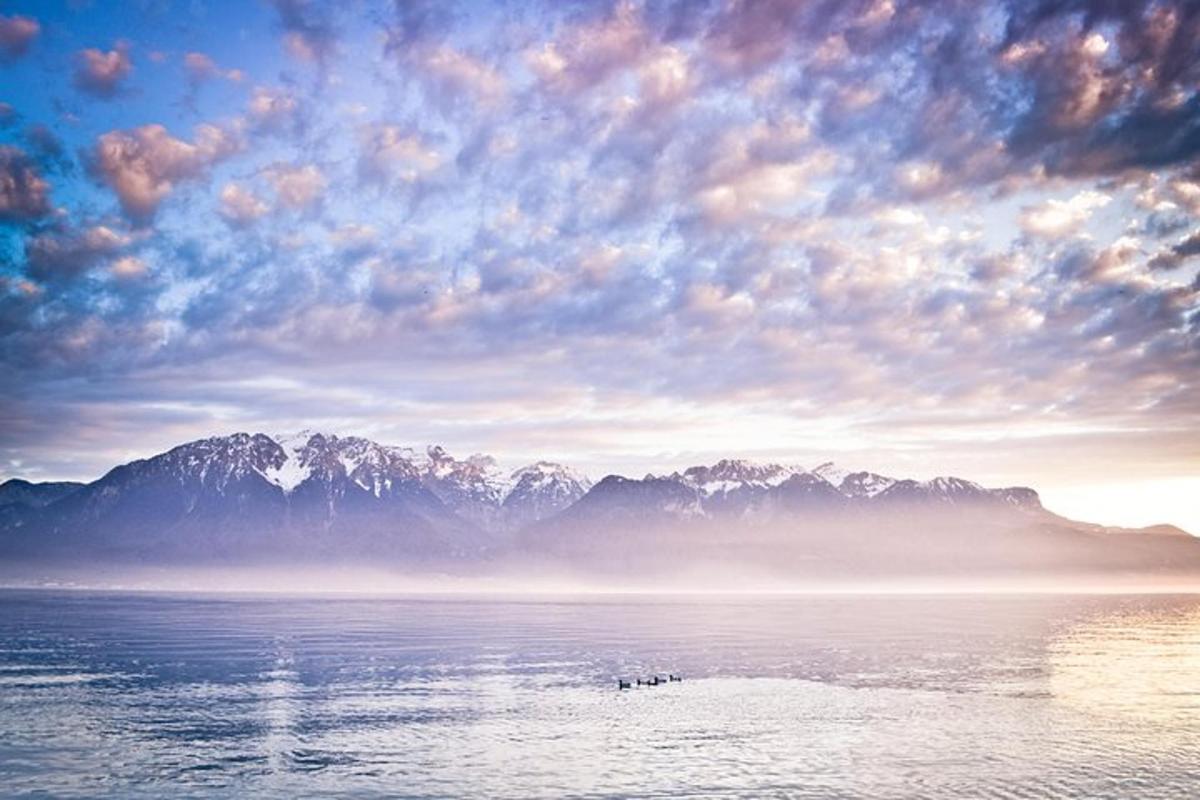 a large body of water with mountains in the background