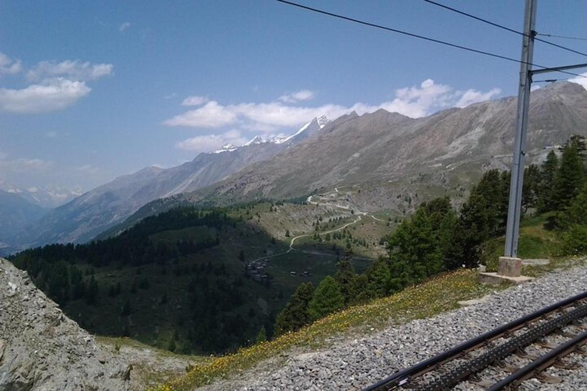 a view of a mountain range with a train track