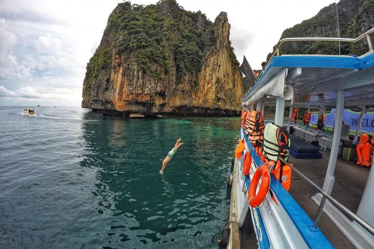 a person jumping into the water from a boat