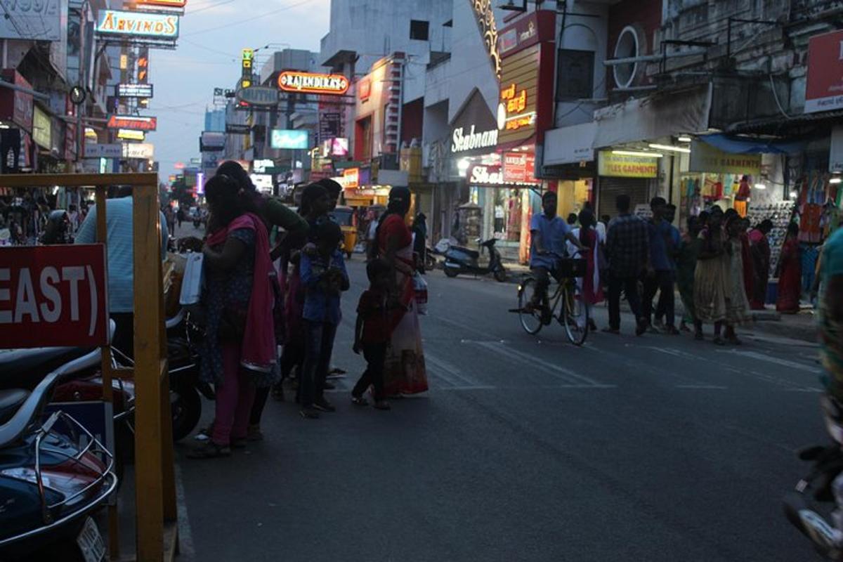 a group of people standing on a busy city street