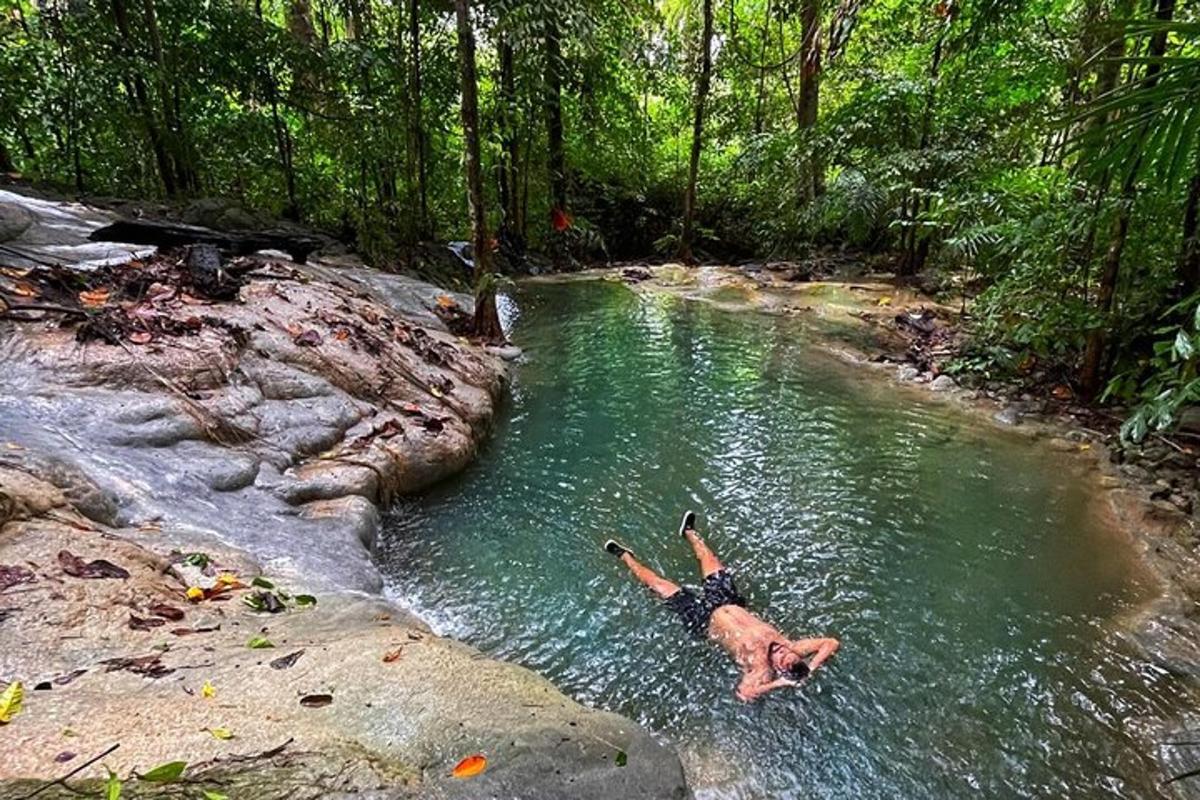 a man laying in the water in a river
