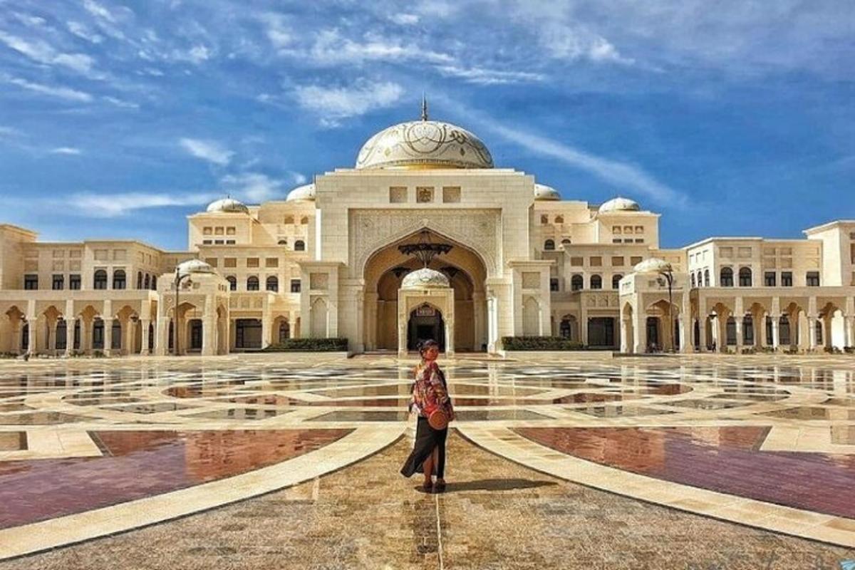 a woman standing in front of a large building