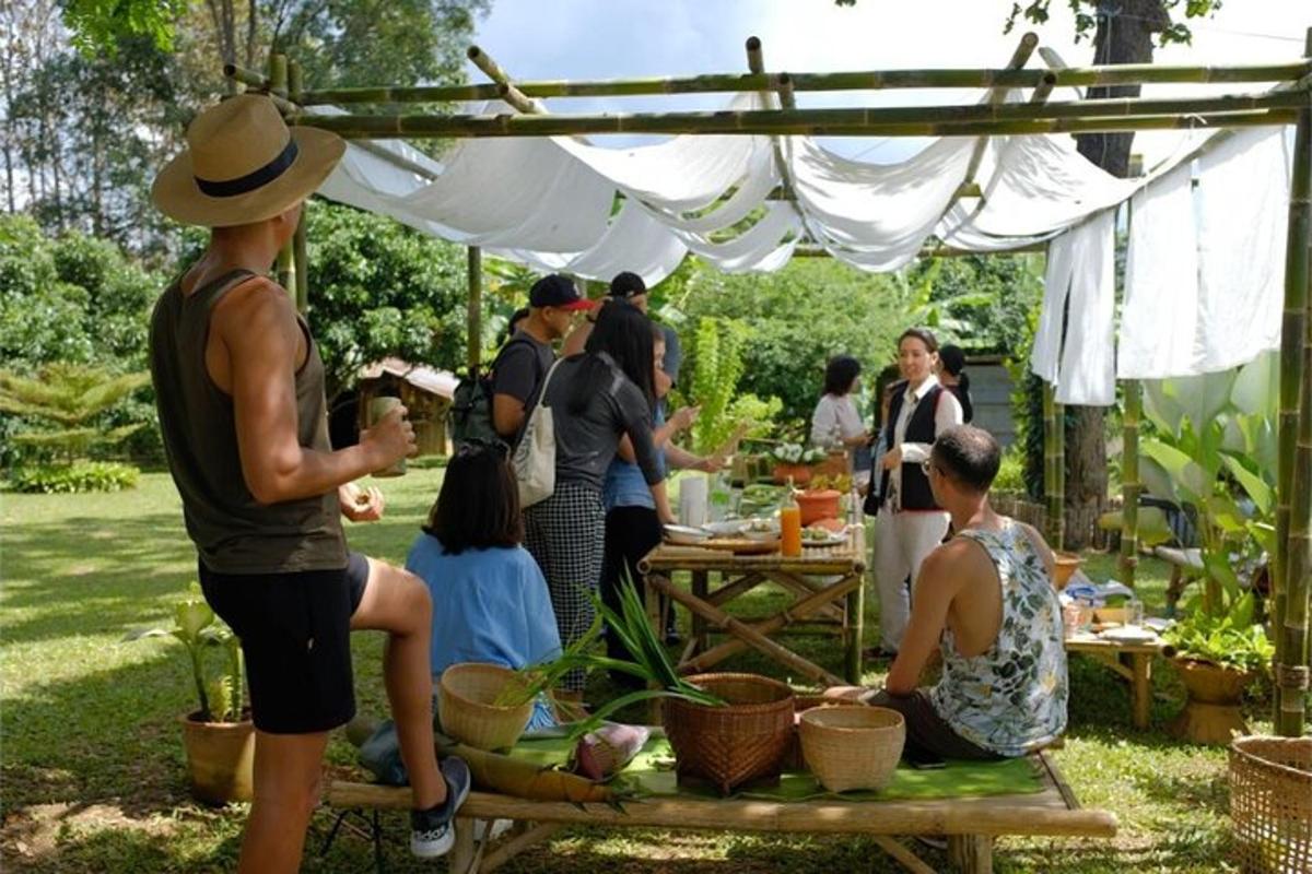 sekumpulan orang berkumpul di bawah khemah di sebuah taman