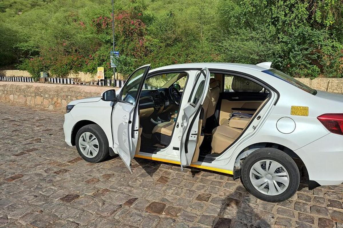 a small white car with its door open