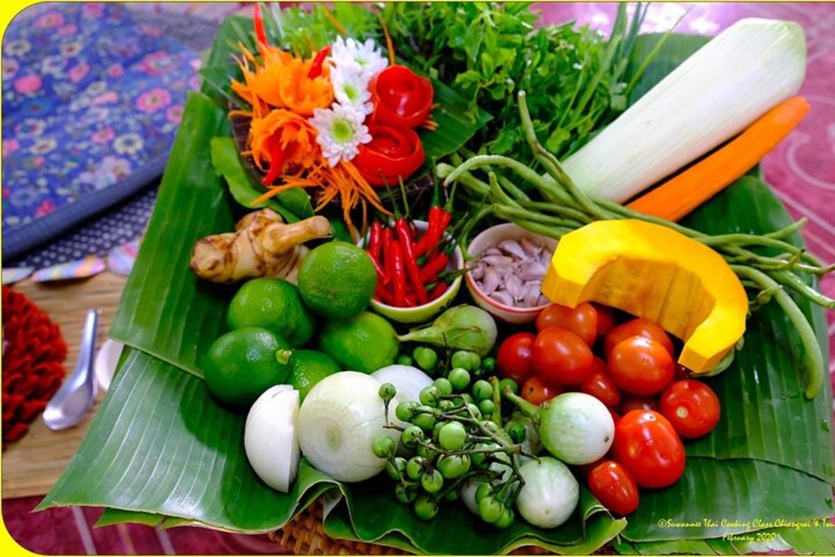 a bunch of fruits and vegetables on a banana leaf