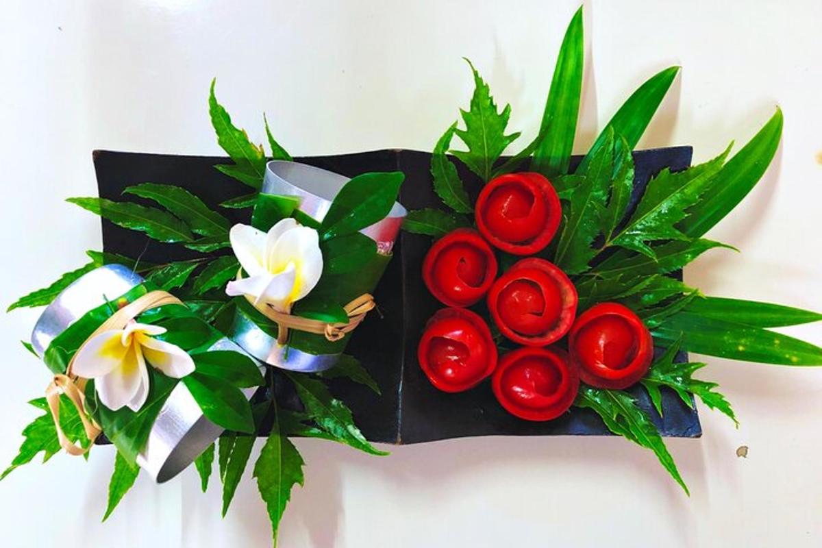 a bouquet of red roses and flowers on a black box