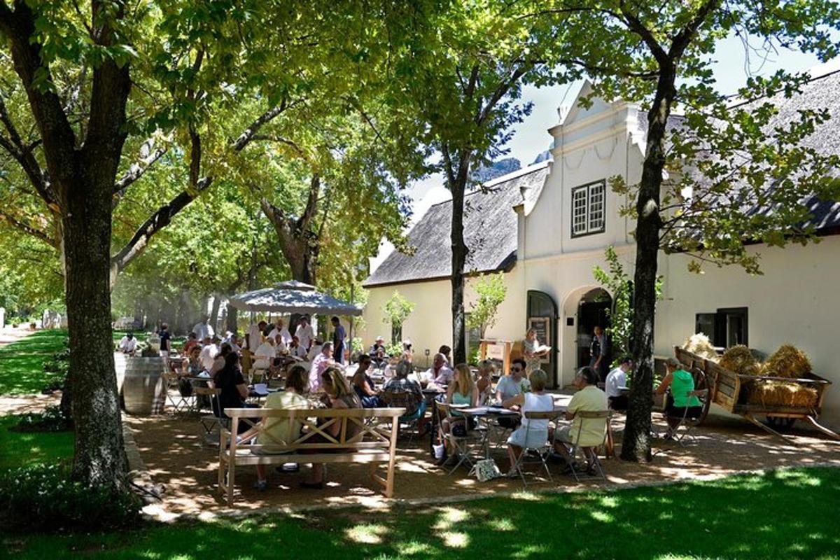 a group of people sitting at tables in front of a building