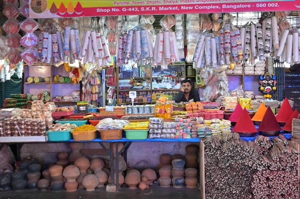 a man is standing in a market selling food