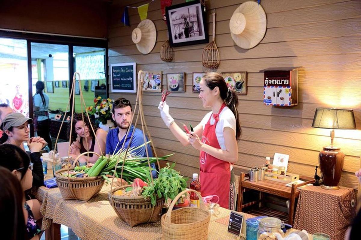 a woman standing in front of a table with vegetables