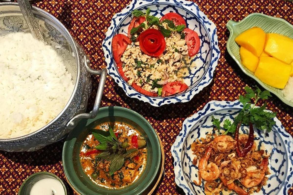 a table topped with plates of food and rice