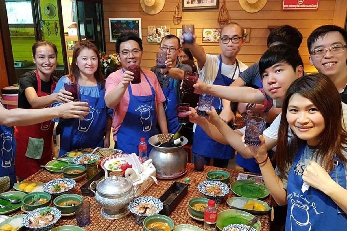 a group of people standing around a table with drinks